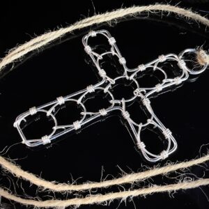 A cross-shaped cilice made of metal complete with traditional manila rope tie-cord