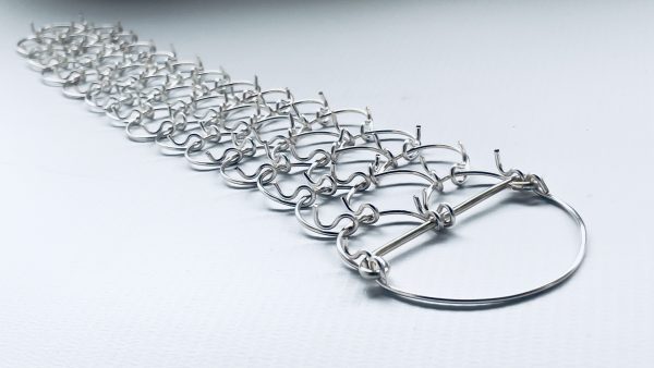 A three link, 1mm gauge half-leg metal cilice with tie-cord