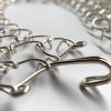 A three link, 1mm gauge full-length waist metal cilice with metal fastener