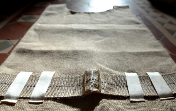 A traditional sack-cloth hairshirt with belt and metal buckle-83